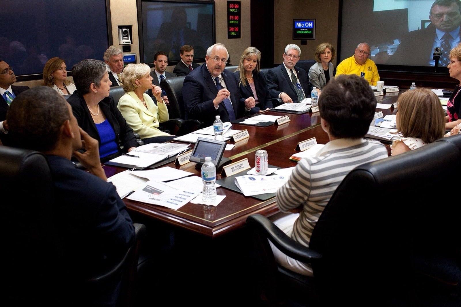 Analysts monitoring global events on screens.